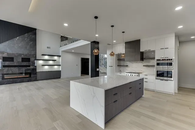 a spacious bathroom with a granite countertop sink a toilet and shower