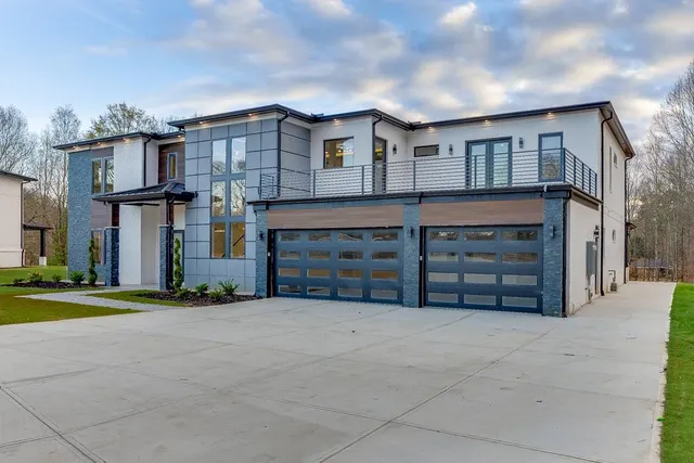 a view of a house with a yard and garage