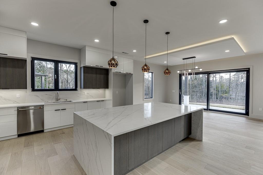 4238 Hamilton Mill Road Buford, GA 30519 - Photo 22 of 100 a large kitchen with a large counter top sink and stainless steel appliances