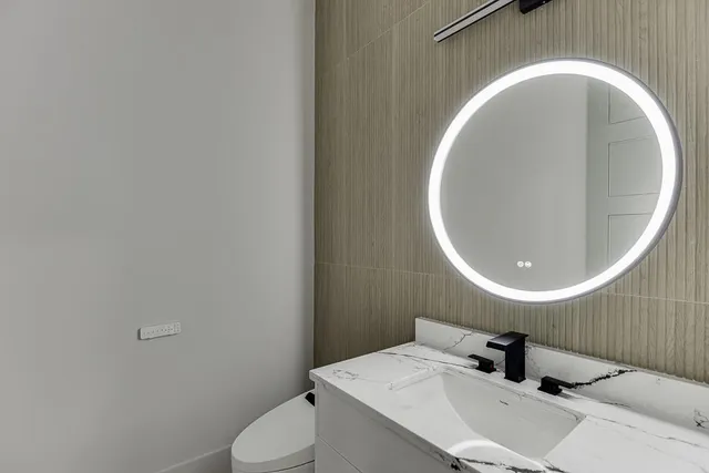 a bathroom with a double vanity sink mirror and shower