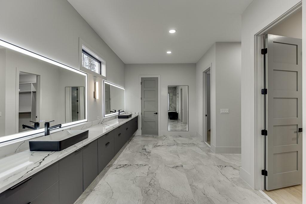 4238 Hamilton Mill Road Buford, GA 30519 - Photo 35 of 100 a large bathroom with a large mirror vanity and shower