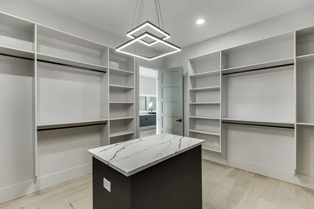 a view of a big house with a big yard and large trees