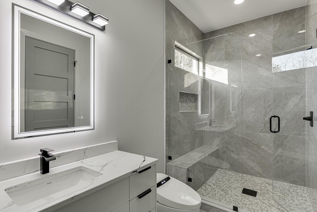 4238 Hamilton Mill Road Buford, GA 30519 - Photo 59 of 100 a bathroom with a sink a toilet and shower