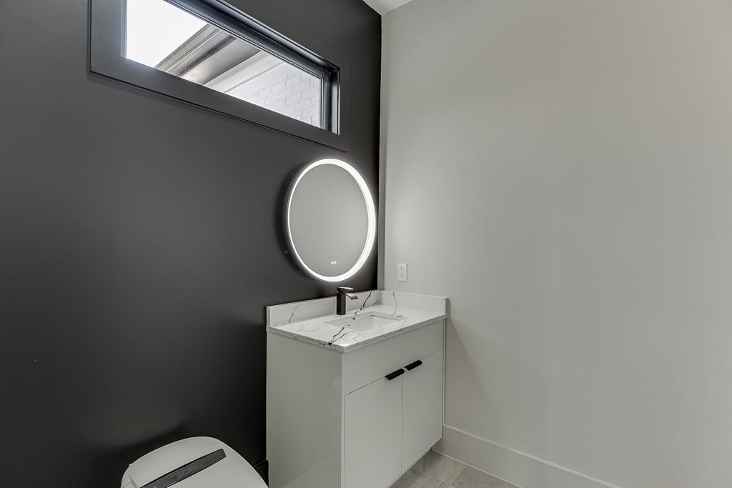4238 Hamilton Mill Road Buford, GA 30519 - Photo 62 of 100 a bathroom with a toilet sink and mirror