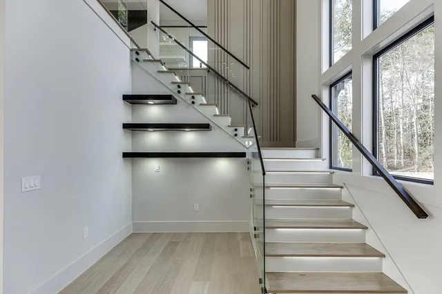 a large kitchen with stainless steel appliances kitchen island a large counter top and a refrigerator