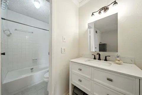 a bathroom with a double vanity sink mirror double and bathtub