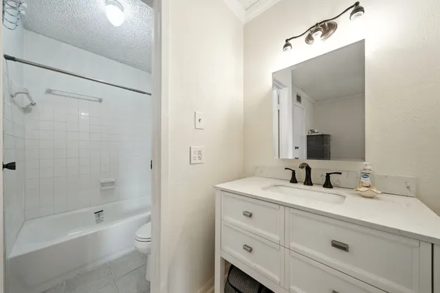 a bathroom with a double vanity sink mirror double and bathtub
