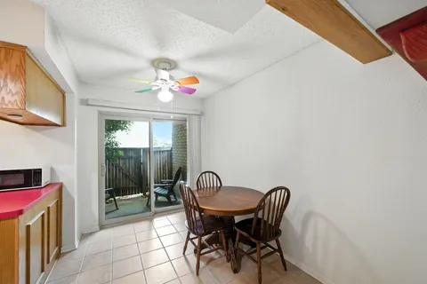 a view of a dining room with furniture and a chandelier