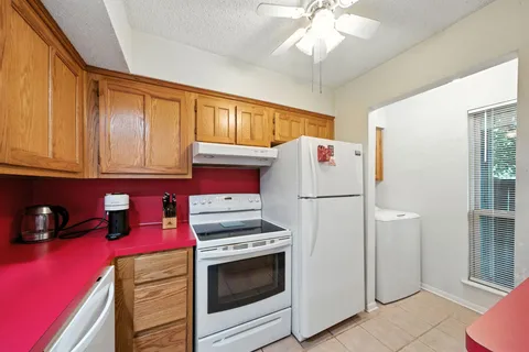 a kitchen with stainless steel appliances a refrigerator sink and cabinets