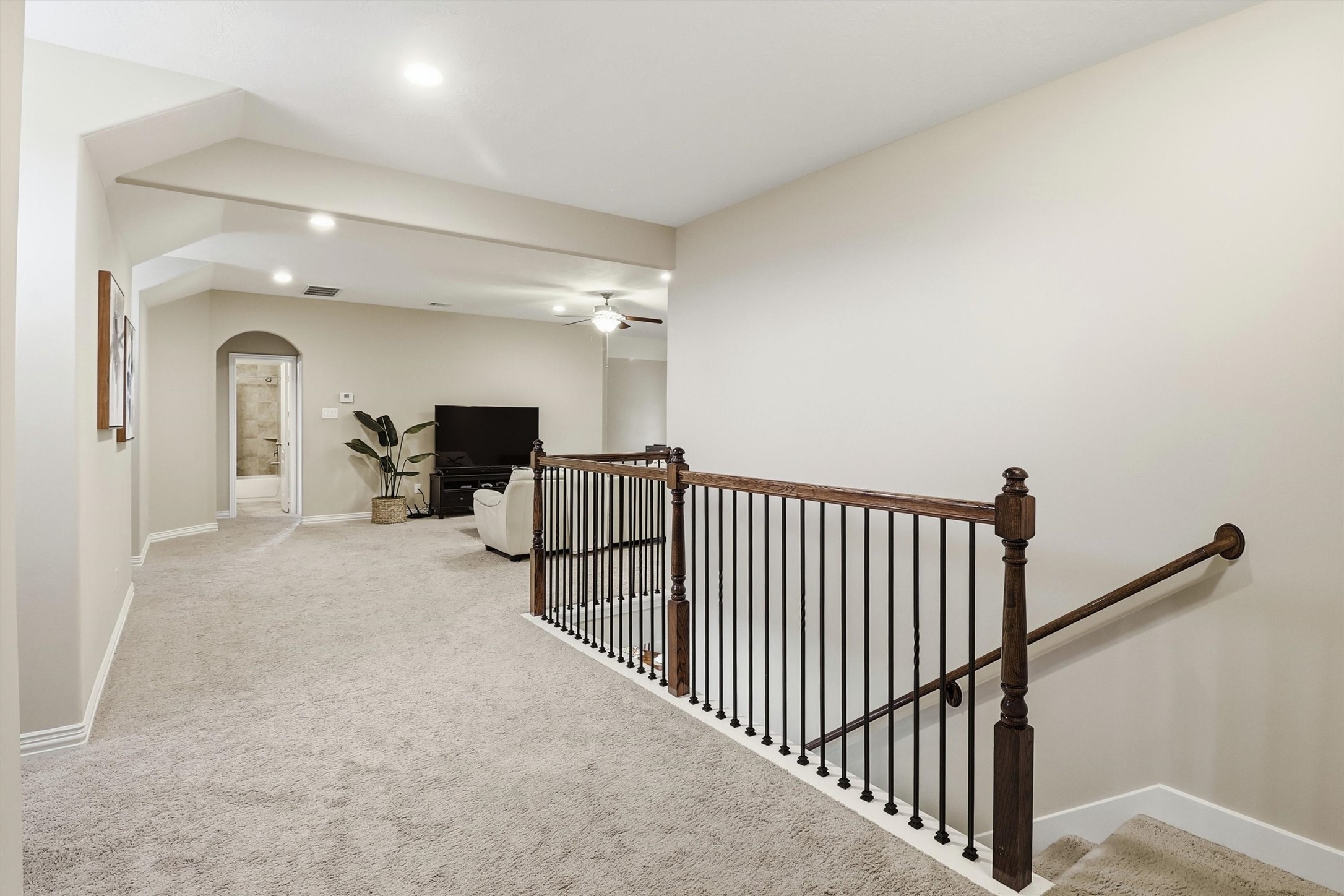 3219 Cotton Ranch Drive Katy, TX 77494 - Photo 24 of 45 Discover the expansive upstairs landing, complete with wrought iron spindles, plush carpeting, and flexible space that connects the game room and secondary bedrooms.