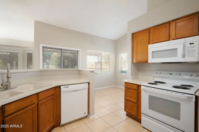 a kitchen with cabinets appliances and a sink
