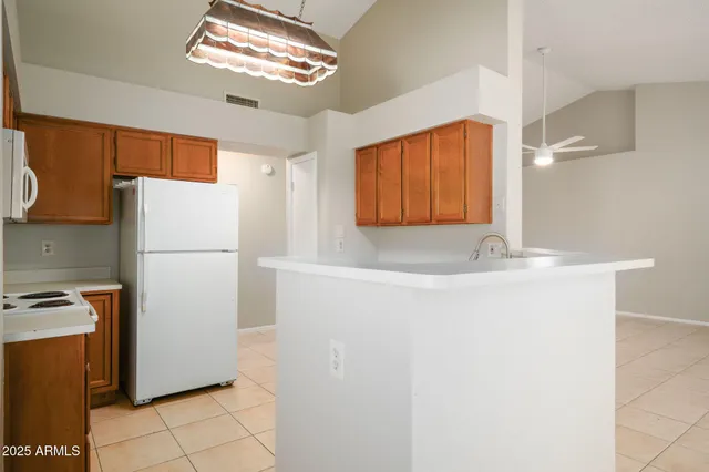 a white refrigerator freezer sitting inside of a kitchen