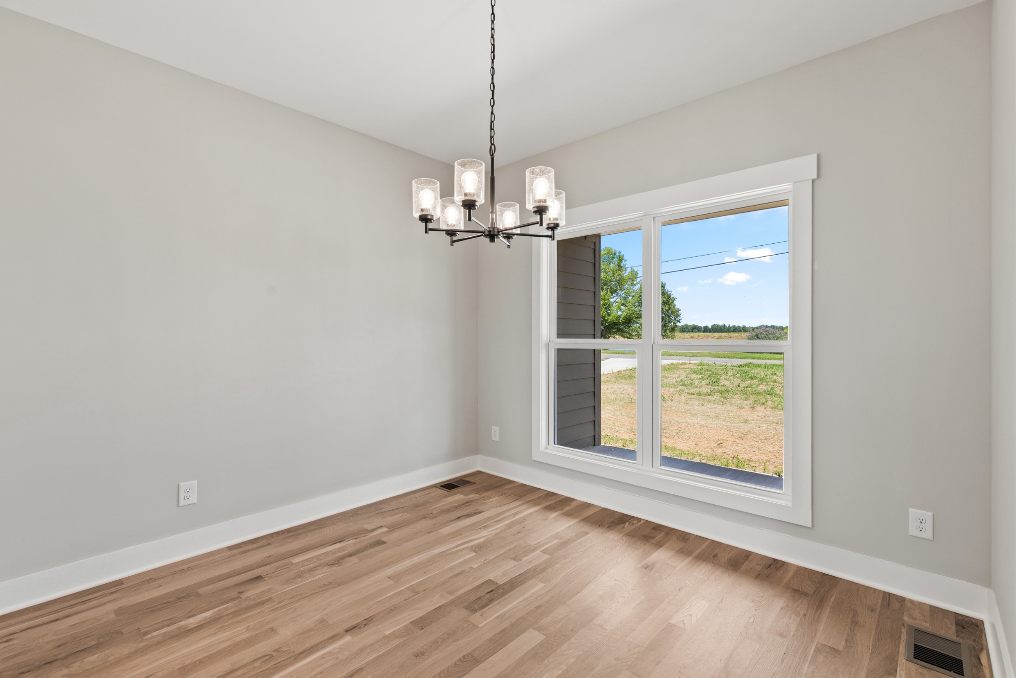 5638 Borthick Road Springfield, TN 37172 - Photo 17 of 43 an empty room with wooden floor chandelier and windows