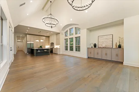 a view of a livingroom with a furniture wooden floor and windows