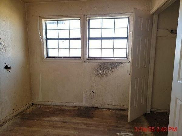 3006 East 3rd Street Lubbock, TX 79403 - Photo 10 of 13 an empty room with wooden floor and windows