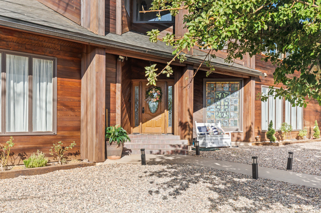 460 Omni Point Road Central Valley, UT 84754 - Photo 4 of 101 Wood-sided exterior featuring a prominent front entrance with a wooden door and sidelights
