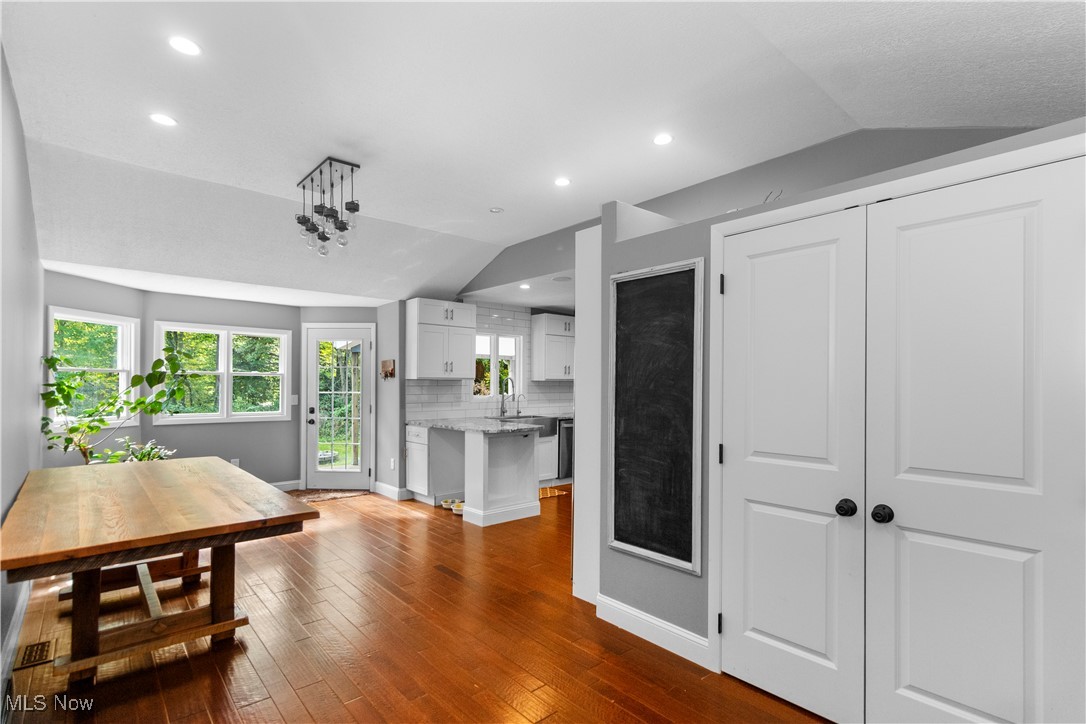 4694 Heather Hills Road Akron, OH 44333 - Photo 5 of 32 Dining space with vaulted ceiling and dark hardwood / wood-style flooring
