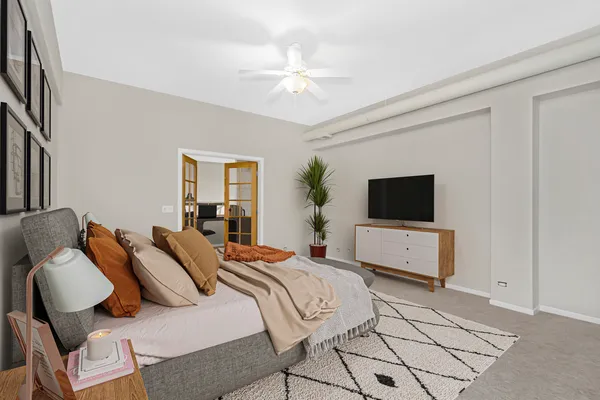 a bedroom with a bed and a flat screen tv