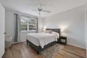 2236 North Cypress Bend Drive, Unit 311 Pompano Beach, FL 33069 - Photo 12 of 56 a bed sitting in a spacious bedroom next to a window