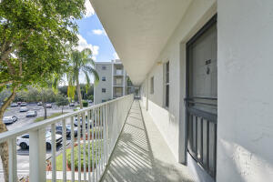 2236 North Cypress Bend Drive, Unit 311 Pompano Beach, FL 33069 - Photo 21 of 56 a view of balcony with wooden floor and fence