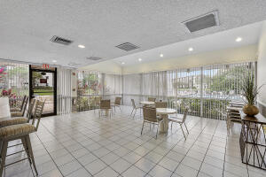 2236 North Cypress Bend Drive, Unit 311 Pompano Beach, FL 33069 - Photo 24 of 56 a dining hall with stainless steel appliances a dining table and chairs