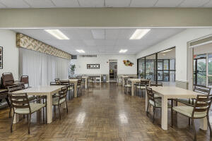 2236 North Cypress Bend Drive, Unit 311 Pompano Beach, FL 33069 - Photo 27 of 56 a view of a dining room with furniture