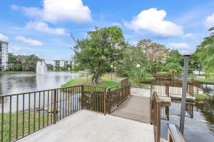 2236 North Cypress Bend Drive, Unit 311 Pompano Beach, FL 33069 - Photo 38 of 56 a balcony with trees in front of it