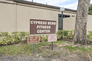 2236 North Cypress Bend Drive, Unit 311 Pompano Beach, FL 33069 - Photo 42 of 56 a sign on the side of a building