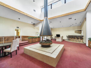 2236 North Cypress Bend Drive, Unit 311 Pompano Beach, FL 33069 - Photo 46 of 56 a kitchen with stainless steel appliances granite countertop a stove and a view of living room