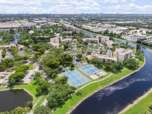 2236 North Cypress Bend Drive, Unit 311 Pompano Beach, FL 33069 - Photo 56 of 56 an aerial view of residential houses with outdoor space and trees
