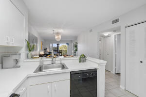 2236 North Cypress Bend Drive, Unit 311 Pompano Beach, FL 33069 - Photo 7 of 56 a kitchen with a sink and cabinets