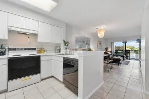 a kitchen with a sink a stove and cabinets