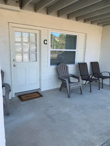 a view of workspace with furniture and window