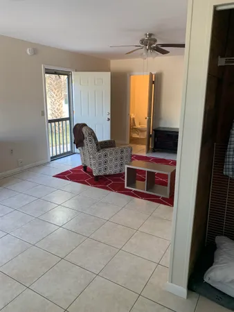 a living room with furniture a window and a flat screen tv