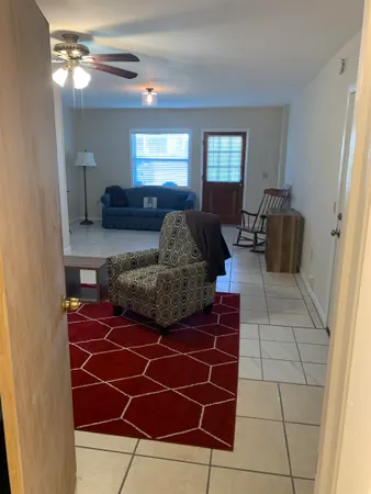 a living room with furniture and a mirror