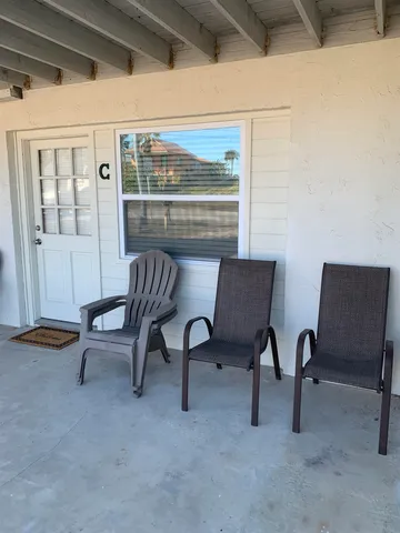 a view of a livingroom with furniture and a window
