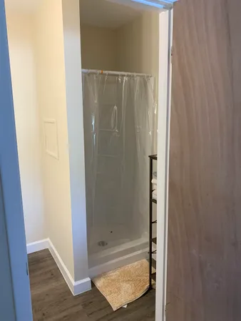 a bathroom with a glass shower door