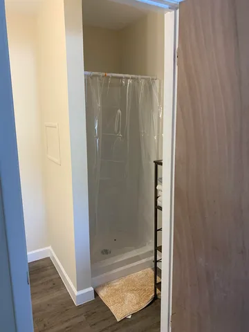 a bathroom with a glass shower door