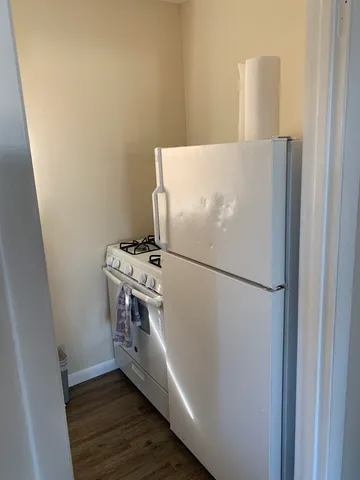 a white refrigerator freezer sitting inside of a kitchen