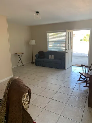 a living room with a couch and a floor to ceiling window