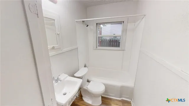 a white toilet sitting next to a bathroom sink