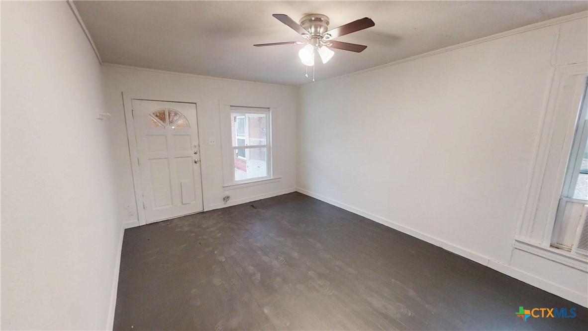 1114 South 2nd Street Temple, TX 76504 - Photo 5 of 13 an empty room with windows and fan