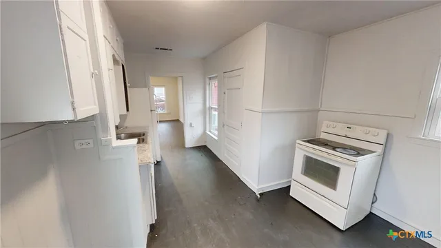 a view of a kitchen with a dishwasher a washer and dryer