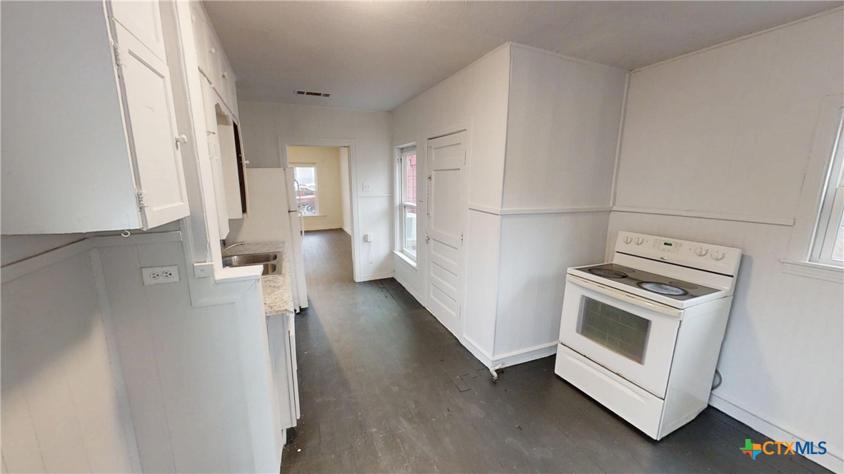 1114 South 2nd Street Temple, TX 76504 - Photo 7 of 13 a view of a kitchen with a dishwasher a washer and dryer