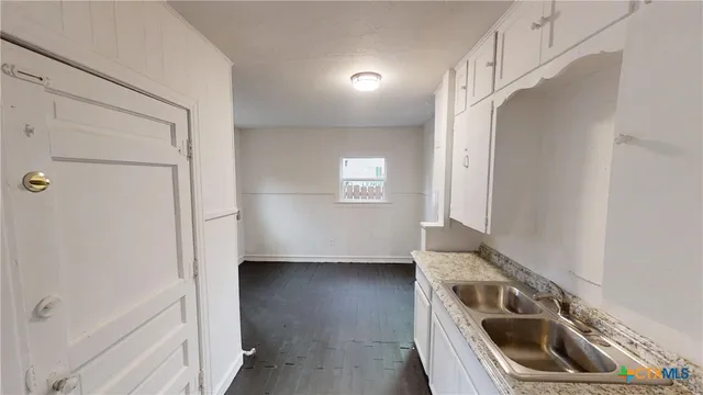 a kitchen with a sink a stove and refrigerator