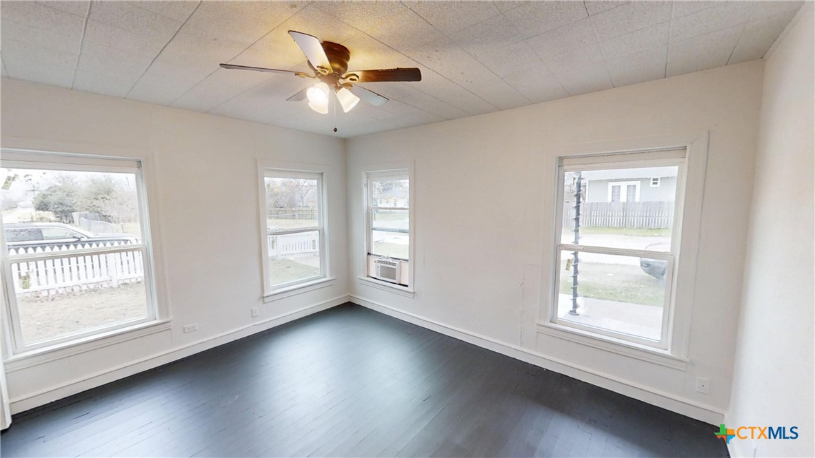 1114 South 2nd Street Temple, TX 76504 - Photo 9 of 13 a view of an empty room with wooden floor and a window