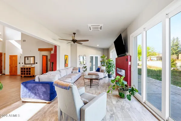a living room with furniture large window and a flat screen tv