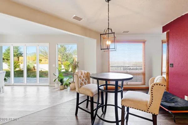 a dining hall with stainless steel appliances granite countertop a kitchen view and chairs
