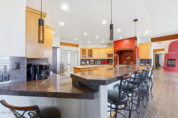 a kitchen with stainless steel appliances a dining table and chairs