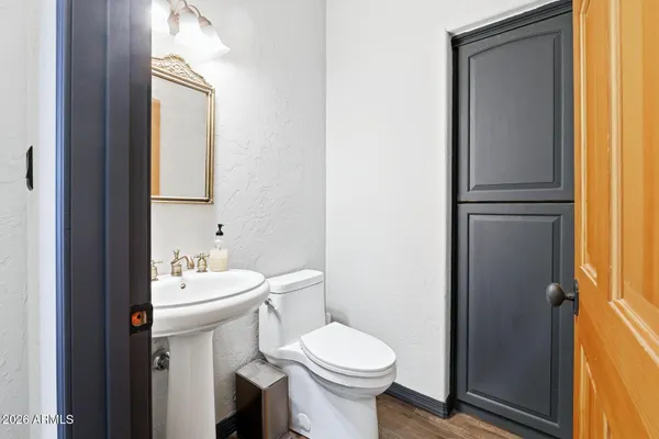 a spacious bedroom with a bed and a chandelier